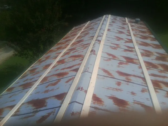 Rusted metal roof panels with new wood purlins before replacement — Storm Damage Roof Repair in Fisherville by Roofing Brothers